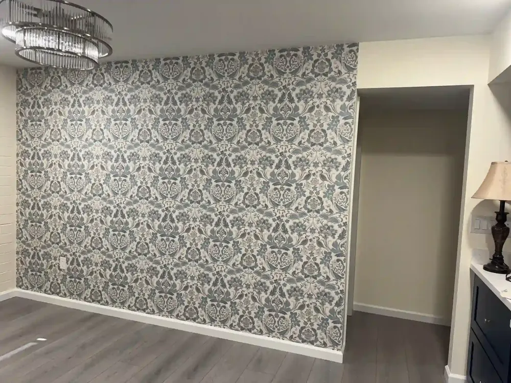 Fine geometric wallpaper pattern across a room wall